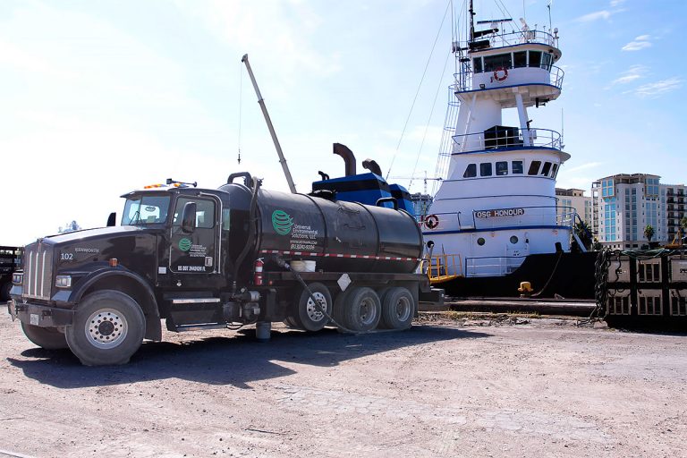 UES vacuum truck removing oily bilge slops from Tug Honour in the Port of Tampa Bay